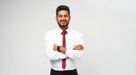 portrait-young-indian-top-manager-t-shirt-tie-crossed-arms-smiling-white-isolated-wall.jpg